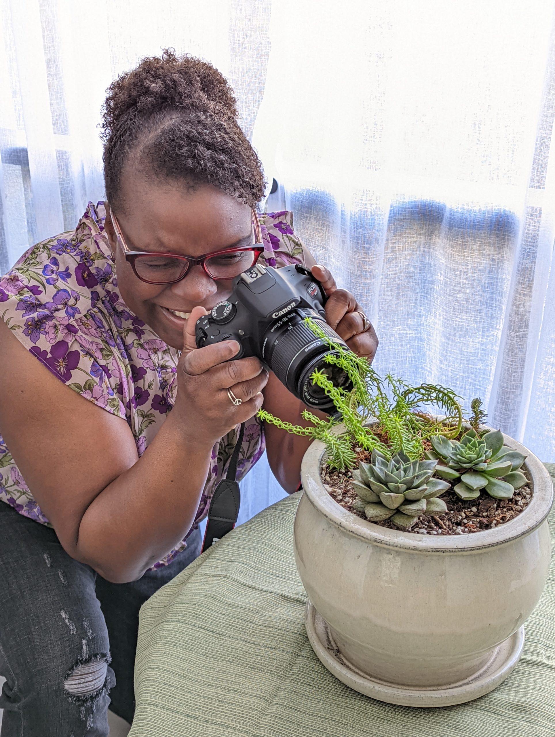 Dr Abigail taking a phot of a plant with a DSLR camera